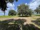 Expansive backyard featuring mature shade trees offering picturesque views of the tranquil lake at 1805 S Lake Reedy Blvd, Frostproof, FL 33843
