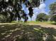 Serene lake view framed by mature trees and moss, enhancing the tranquility of the expansive backyard at 1805 S Lake Reedy Blvd, Frostproof, FL 33843
