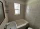 Bathroom featuring a bathtub, sink and tile walls at 1805 S Lake Reedy Blvd, Frostproof, FL 33843