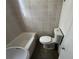 Tiled bathroom featuring a bathtub and a toilet at 1805 S Lake Reedy Blvd, Frostproof, FL 33843