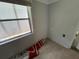 Cozy bedroom featuring a bright window and tiled flooring at 1805 S Lake Reedy Blvd, Frostproof, FL 33843
