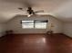 Bedroom with hardwood floors, a ceiling fan, and two windows at 1805 S Lake Reedy Blvd, Frostproof, FL 33843