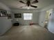 Bright bedroom with neutral tones, featuring a ceiling fan and adjacent bathroom access at 1805 S Lake Reedy Blvd, Frostproof, FL 33843