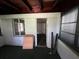 Bright enclosed porch with wooden ceiling and lots of natural light from the windows at 1805 S Lake Reedy Blvd, Frostproof, FL 33843
