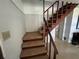Carpeted staircase with wooden railing leading to the upper level, providing access to bedrooms at 1805 S Lake Reedy Blvd, Frostproof, FL 33843