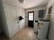 Practical utility room with a hot water tank, washer, and additional storage cabinets at 1805 S Lake Reedy Blvd, Frostproof, FL 33843