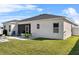 Large backyard with a screened porch and modern outdoor furniture on the white gravel at 185 St Thomas Dr, Mulberry, FL 33860