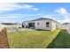 Wide-open backyard space features a well-manicured lawn, gravel space, and patio furniture at 185 St Thomas Dr, Mulberry, FL 33860