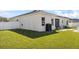 Spacious backyard features a pristine lawn and comfortable patio furniture at 185 St Thomas Dr, Mulberry, FL 33860