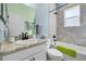 Cozy bathroom featuring a shower-tub combo and a single sink vanity with drawers at 185 St Thomas Dr, Mulberry, FL 33860