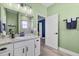 Bathroom showcasing a single sink vanity and view into a second bedroom at 185 St Thomas Dr, Mulberry, FL 33860