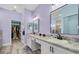 Bathroom features double vanity, framed mirrors, and wood-look floors at 185 St Thomas Dr, Mulberry, FL 33860