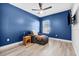 Cozy bedroom with natural light, chair with ottoman, ceiling fan, and wood look flooring at 185 St Thomas Dr, Mulberry, FL 33860