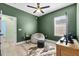 Bedroom featuring a beanbag, fan, and a mounted TV for relaxed entertainment at 185 St Thomas Dr, Mulberry, FL 33860