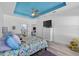 Spacious bedroom with tray ceiling, ceiling fan, and cozy decor at 185 St Thomas Dr, Mulberry, FL 33860