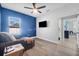Bright bedroom featuring a cozy armchair, tv, ceiling fan, and a natural light from the window at 185 St Thomas Dr, Mulberry, FL 33860