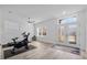Bright exercise room with light wood floors, a ceiling fan, and an entrance with a transom window at 185 St Thomas Dr, Mulberry, FL 33860