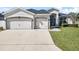 Charming single-story home featuring a well-maintained lawn, a two-car garage, and a welcoming entrance at 185 St Thomas Dr, Mulberry, FL 33860