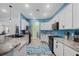 Open kitchen with stainless steel appliances, marble countertops, and white cabinetry at 185 St Thomas Dr, Mulberry, FL 33860