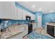 Bright kitchen features white cabinetry, modern appliances, and stylish countertops at 185 St Thomas Dr, Mulberry, FL 33860