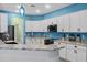 A bright kitchen with white cabinets, a corner countertop, and stainless steel appliances at 185 St Thomas Dr, Mulberry, FL 33860