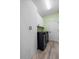 Laundry room showcasing modern black washer and dryer with white cabinets for ample storage space at 185 St Thomas Dr, Mulberry, FL 33860