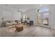 Living room features a ceiling fan, hard-surface floors, a couch, and natural light at 185 St Thomas Dr, Mulberry, FL 33860