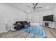 Cozy living room with a ceiling fan, gray sofa, blue rug, and a view to the doorway at 185 St Thomas Dr, Mulberry, FL 33860