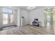 Office area features hard-surface floors, a desk with a computer, and natural light from the front door at 185 St Thomas Dr, Mulberry, FL 33860