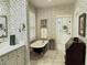 Charming bathroom featuring a clawfoot tub, decorative wallpaper, and ample natural light for a spa-like experience at 1976 Holy Cow Rd, Polk City, FL 33868