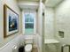 Modern bathroom with a glass-enclosed shower, built-in bench, and neutral tones, creating a clean and relaxing space at 1976 Holy Cow Rd, Polk City, FL 33868