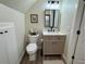 A well-lit bathroom featuring a vanity with storage, modern fixtures and a toilet at 1976 Holy Cow Rd, Polk City, FL 33868