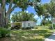 Charming single-story home for sale featuring lush landscaping and a sprawling front lawn at 1976 Holy Cow Rd, Polk City, FL 33868