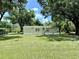 Single-story home for sale features well-maintained siding and an expansive front yard at 1976 Holy Cow Rd, Polk City, FL 33868
