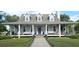Charming one-story home featuring a long porch, large windows, and a well-manicured lawn at 1976 Holy Cow Rd, Polk City, FL 33868