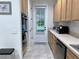 Bright and functional kitchen with wood cabinets, modern appliances, and a view to the outdoors through the door at 1976 Holy Cow Rd, Polk City, FL 33868