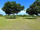 Expansive lot for sale featuring level ground, a metal shelter, and scattered mature trees at 1976 Holy Cow Rd, Polk City, FL 33868