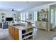 Open-concept living space featuring a kitchen island, comfortable seating, and natural light, great for entertaining at 1976 Holy Cow Rd, Polk City, FL 33868