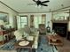 Cozy living room featuring a decorative fireplace, comfortable seating, and natural light at 1976 Holy Cow Rd, Polk City, FL 33868