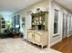 Stylish living room features a vintage cabinet, large windows, and comfortable seating, creating a welcoming space at 1976 Holy Cow Rd, Polk City, FL 33868