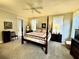Inviting main bedroom with a four-poster bed, ample natural light, and elegant decor for a relaxing retreat at 1976 Holy Cow Rd, Polk City, FL 33868