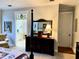 Spacious main bedroom featuring a decorative dresser and a glimpse of the en-suite bathroom for added convenience at 1976 Holy Cow Rd, Polk City, FL 33868