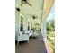 This lovely porch features ample seating and ceiling fans, offering a relaxing outdoor space at 1976 Holy Cow Rd, Polk City, FL 33868