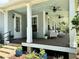 Covered porch with wood floors and ample seating, plus ceiling fans at 1976 Holy Cow Rd, Polk City, FL 33868