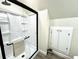Bathroom featuring a sleek glass shower with storage shelving and black accents at 1976 Holy Cow Rd, Polk City, FL 33868