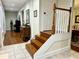 Elegant staircase with wooden steps and white railing leading to the upper floor at 1976 Holy Cow Rd, Polk City, FL 33868