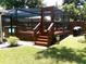 Backyard featuring a raised deck with a fully enclosed, screened in room perfect for enjoying the outdoors at 2021 Oliver Pl, Winter Haven, FL 33881