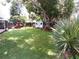View of the backyard with a chicken coop, a swing and a storage shed at 2021 Oliver Pl, Winter Haven, FL 33881