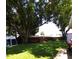 Large shade tree and a swing set in backyard at 2021 Oliver Pl, Winter Haven, FL 33881