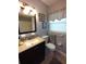 Stylish bathroom with granite vanity and decorative mirror at 2021 Oliver Pl, Winter Haven, FL 33881